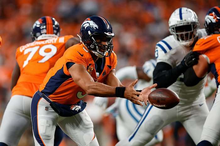 Denver Broncos quarterback Russell Wilson (3) shovel passes the ball in the first quarter against the Indianapolis Colts at Empower Field at Mile High.